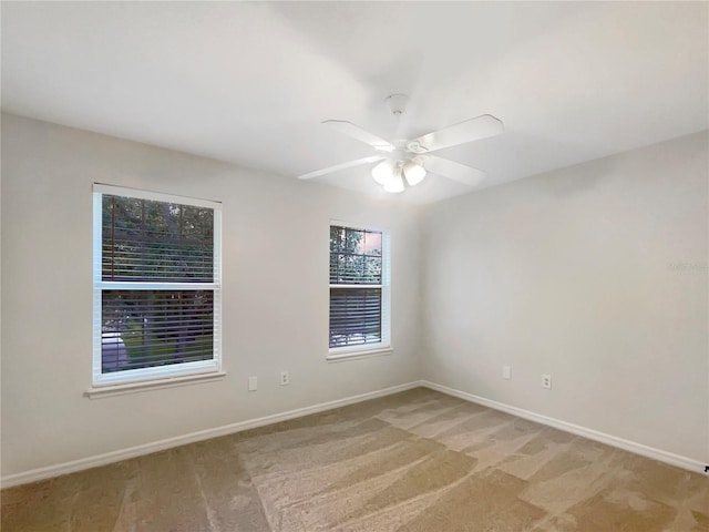 unfurnished room featuring ceiling fan and light colored carpet