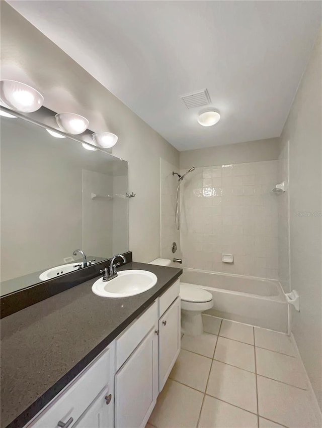 bathroom with tile patterned flooring, toilet, vanity, visible vents, and shower / washtub combination