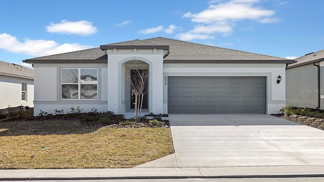 view of front of home with a garage and a front yard