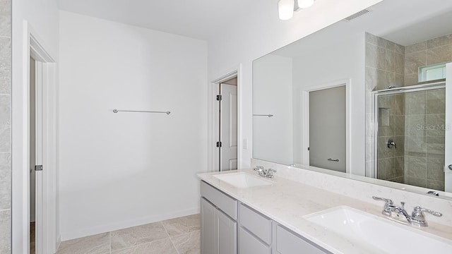 bathroom with vanity, an enclosed shower, and tile patterned floors