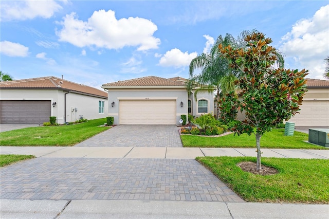 view of front facade with a front yard and a garage