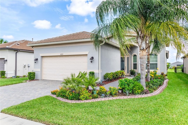 view of front of home with a garage and a front yard