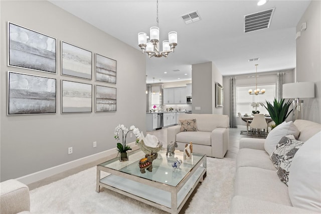 carpeted living room featuring an inviting chandelier