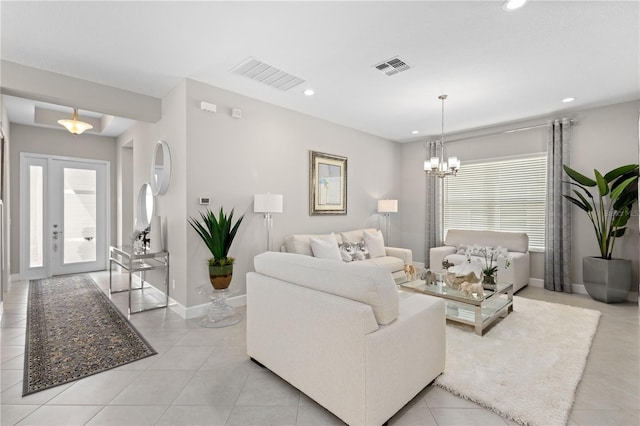 tiled living room featuring a wealth of natural light and a chandelier