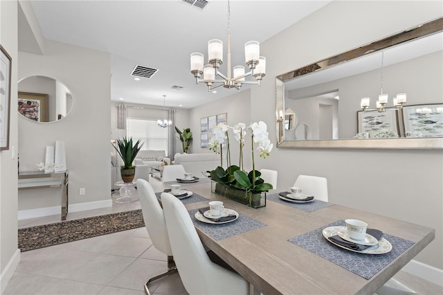 dining space featuring an inviting chandelier and light tile patterned floors