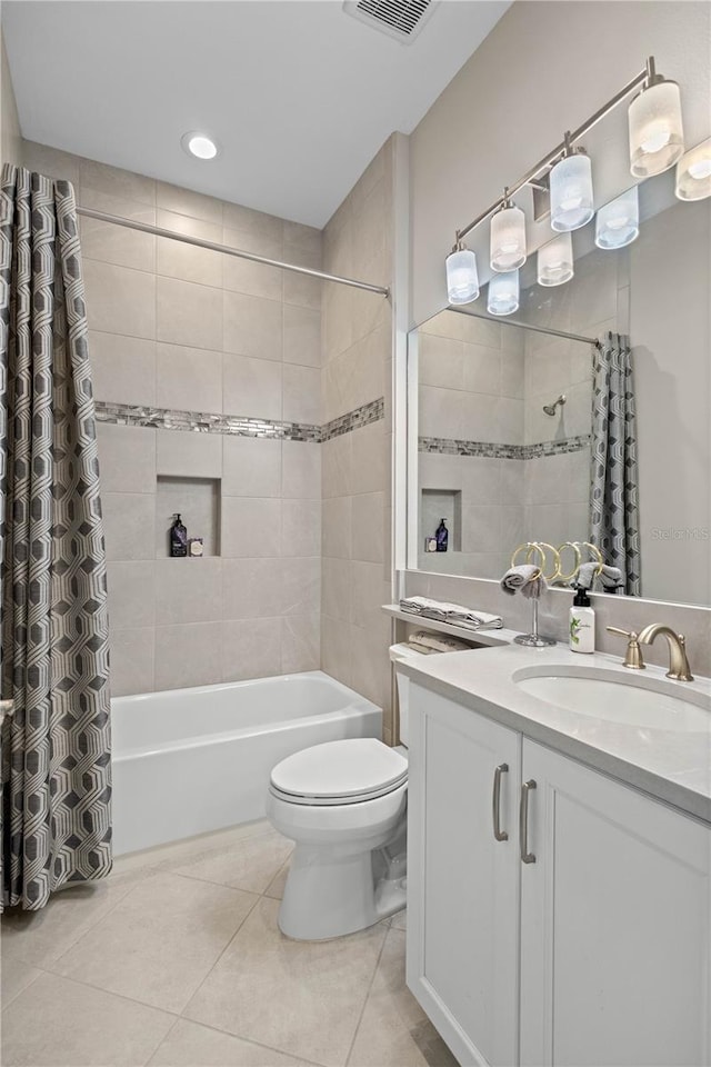 full bathroom with toilet, vanity, shower / bath combo with shower curtain, and tile patterned floors