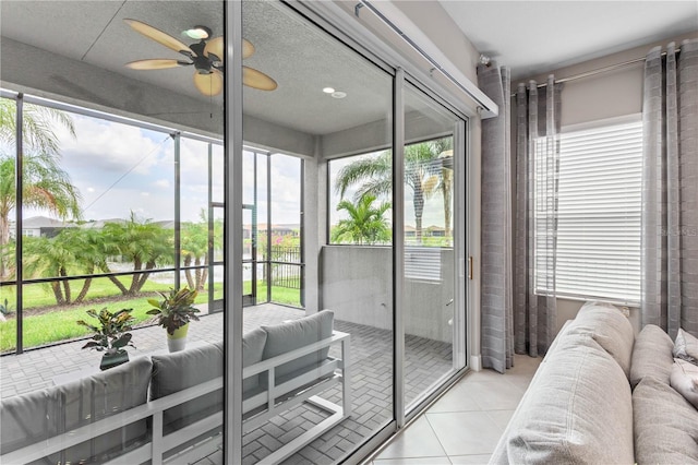 sunroom with ceiling fan and a healthy amount of sunlight