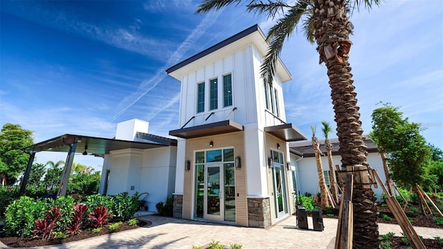 rear view of house featuring a patio area and french doors