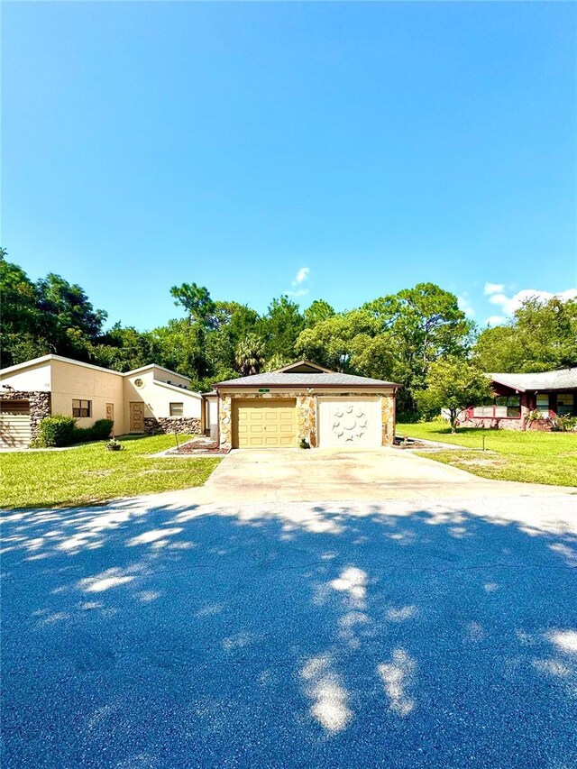 view of front of home with a garage and a front lawn