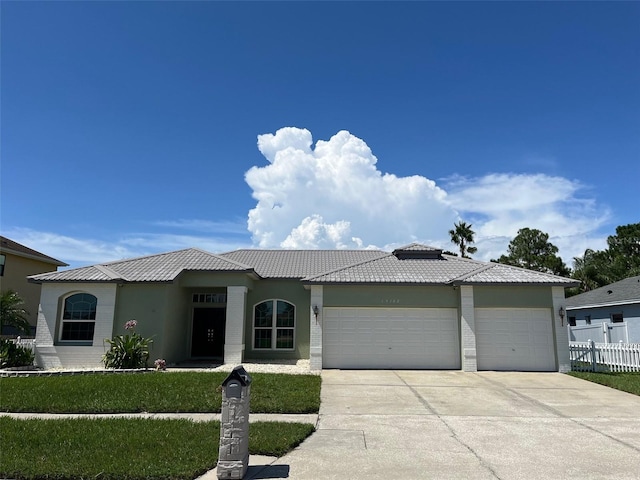 view of front of property with a garage and a front yard