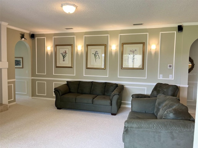 living room featuring a textured ceiling, carpet, and ornamental molding