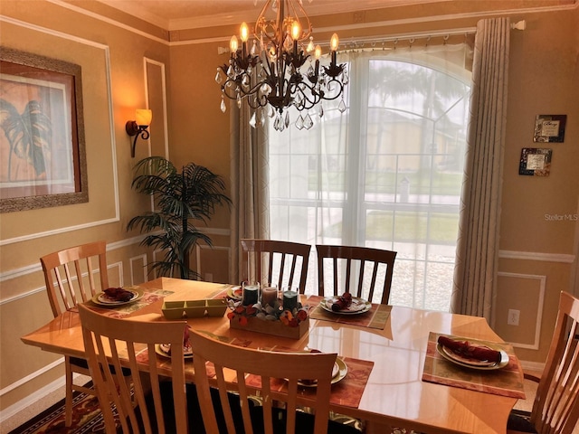 dining area featuring crown molding and an inviting chandelier