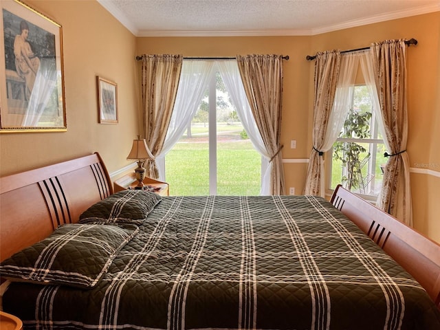 bedroom featuring a textured ceiling and ornamental molding