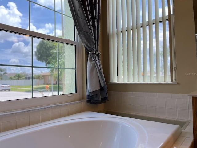 bathroom with a relaxing tiled tub