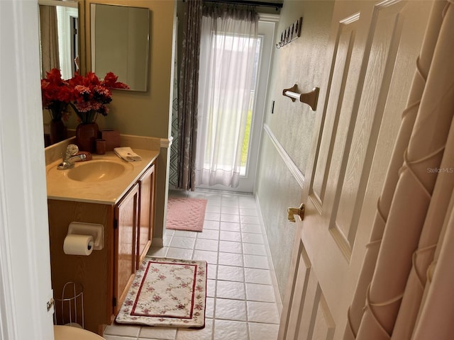 bathroom with tile patterned floors and vanity