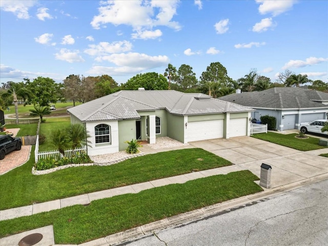 ranch-style home featuring fence, a tiled roof, concrete driveway, a front yard, and a garage