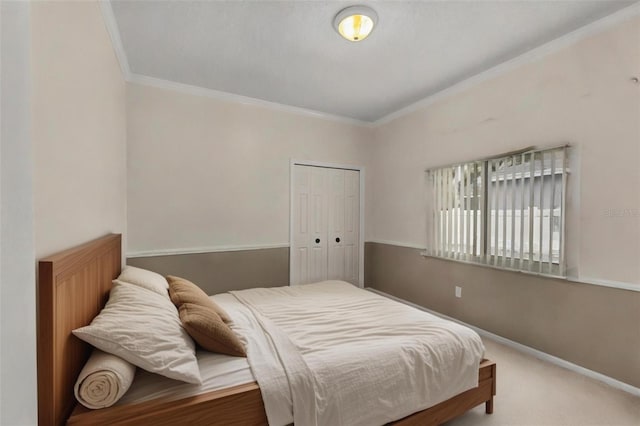 bedroom with crown molding, a closet, baseboards, and carpet floors