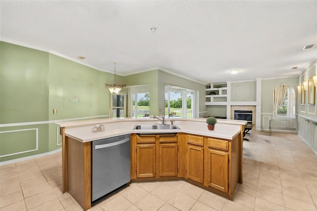 kitchen featuring stainless steel dishwasher, brown cabinets, light countertops, and a sink