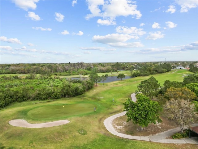 birds eye view of property with a water view and view of golf course
