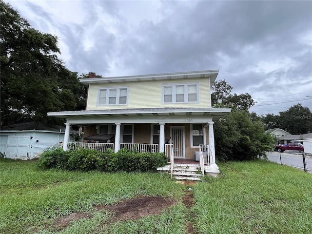 view of front of house with a porch and a front yard