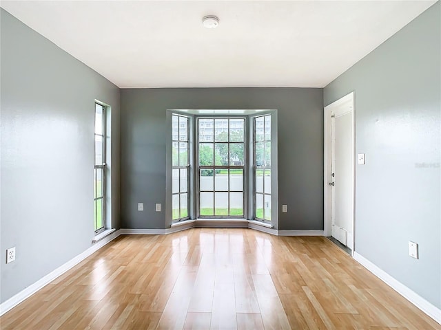 unfurnished room featuring light wood-style floors and baseboards