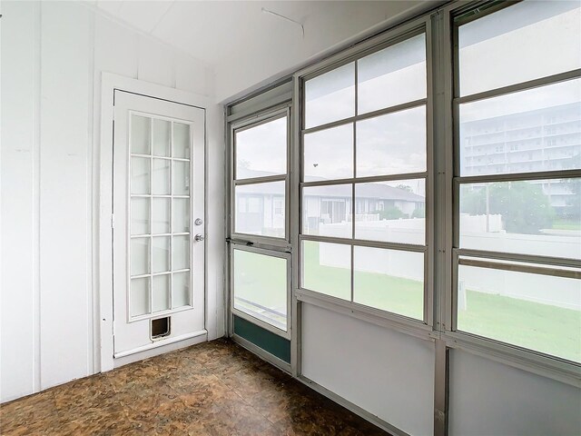 unfurnished sunroom featuring a wealth of natural light