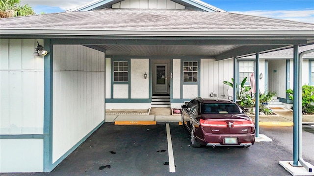 view of front of home featuring covered parking, board and batten siding, and a shingled roof