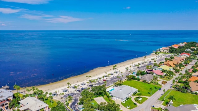 drone / aerial view featuring a beach view and a water view