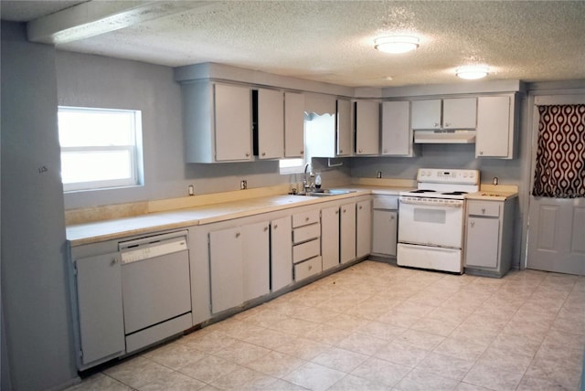 kitchen featuring light tile patterned floors, sink, gray cabinets, and white appliances