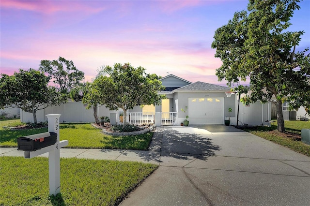 view of front facade with a lawn and a garage