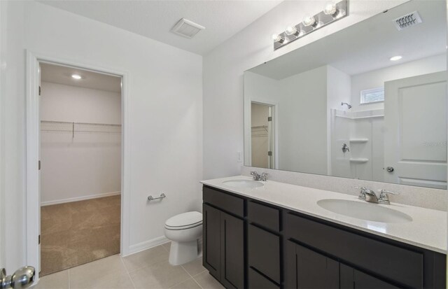 bathroom featuring tile patterned flooring, vanity, and toilet