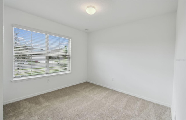 unfurnished room with light colored carpet