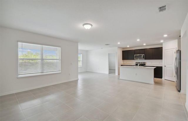 unfurnished living room with light tile patterned floors