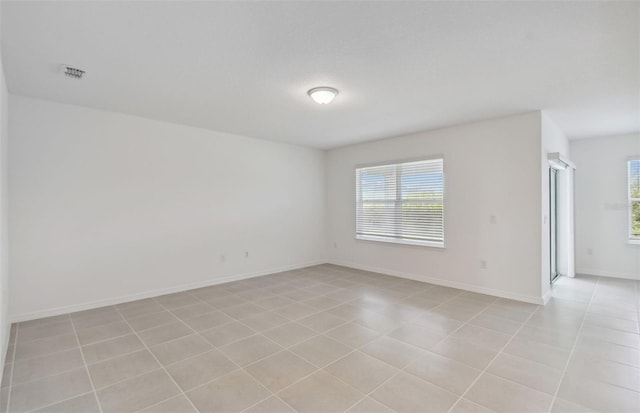 unfurnished room with light tile patterned floors