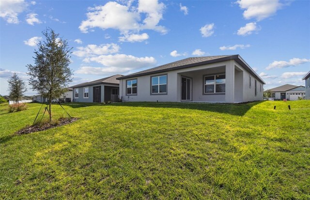 rear view of property with a lawn