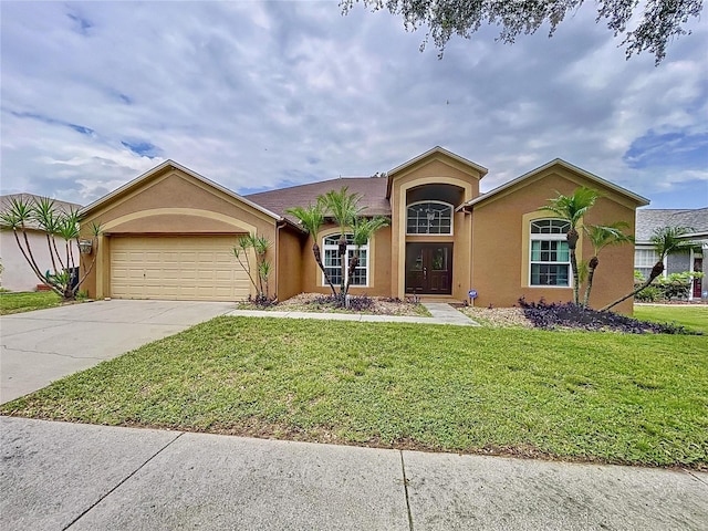 ranch-style home with a garage and a front yard