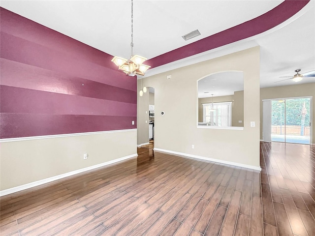 interior space featuring ceiling fan with notable chandelier and hardwood / wood-style floors