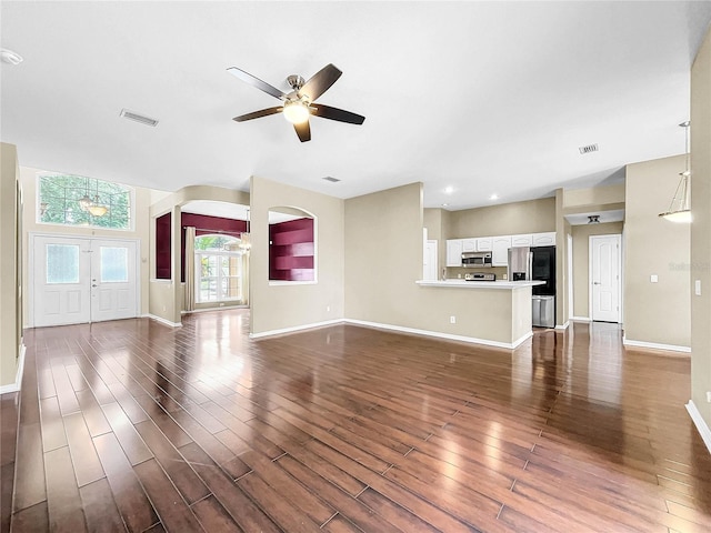 unfurnished living room with hardwood / wood-style floors, french doors, and ceiling fan