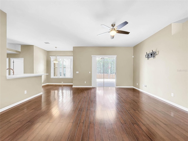 spare room with ceiling fan and dark hardwood / wood-style flooring