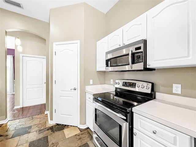 kitchen featuring hardwood / wood-style flooring, white cabinetry, and stainless steel appliances