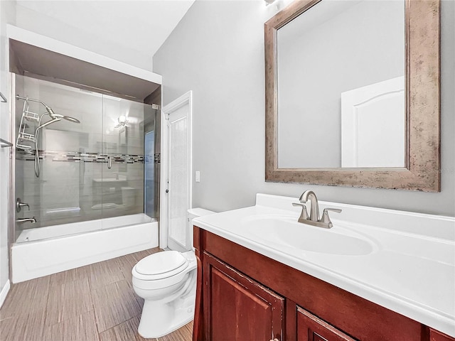 full bathroom with toilet, vanity, and enclosed tub / shower combo