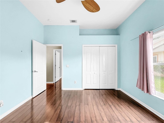 unfurnished bedroom with a closet, ceiling fan, and hardwood / wood-style floors