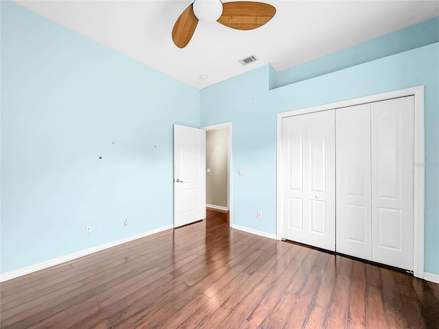 unfurnished bedroom with ceiling fan, hardwood / wood-style flooring, and a closet