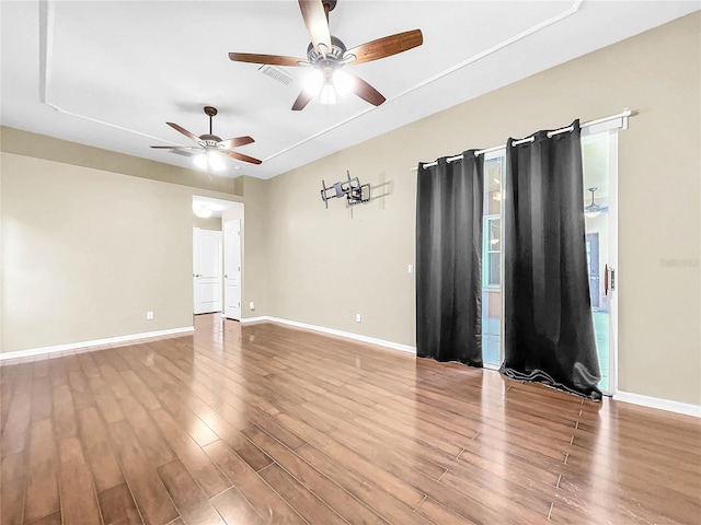 empty room featuring ceiling fan and hardwood / wood-style flooring