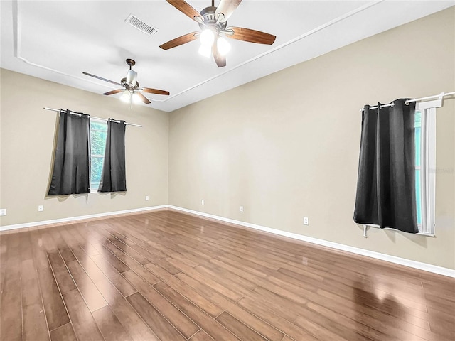 spare room with ceiling fan and wood-type flooring