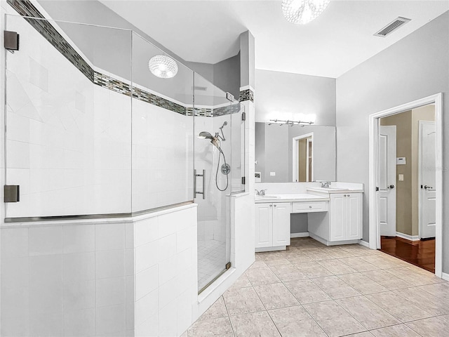 bathroom featuring a shower with shower door, hardwood / wood-style flooring, and vanity