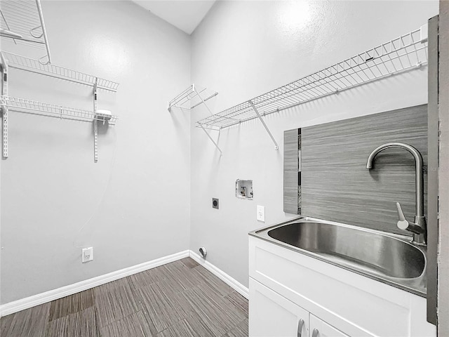 clothes washing area featuring sink, electric dryer hookup, cabinets, and hookup for a washing machine