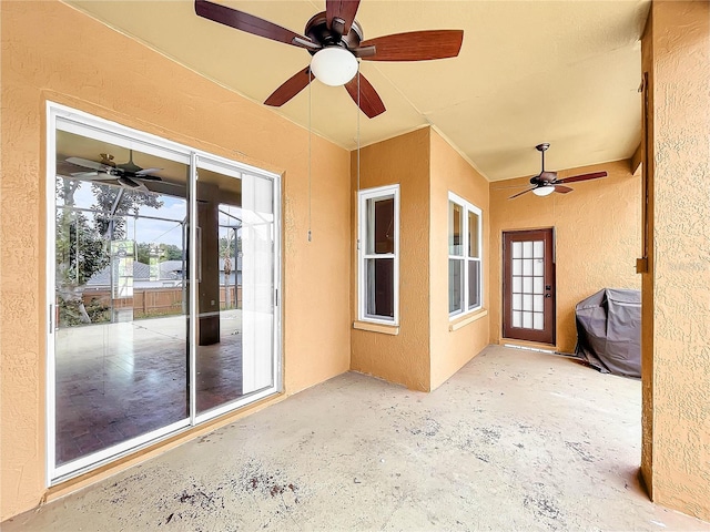 view of patio with ceiling fan and a grill