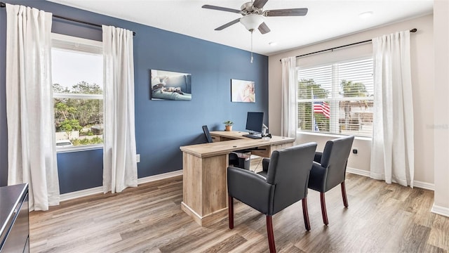 office featuring a ceiling fan, baseboards, and wood finished floors