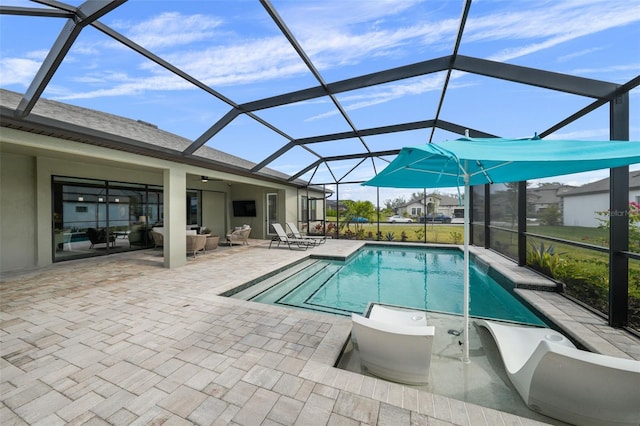 pool with ceiling fan, a lanai, and a patio area